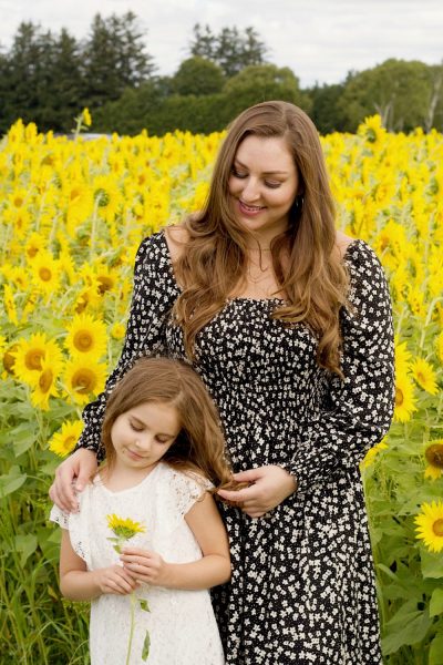Mother and daughter in sunflower field
